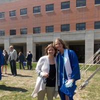 Graduate stands with her mother outside after the graduation ceremony